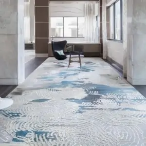 A large lobby carpet featuring intricate blue and white designs, adding a stylish touch to the room's decor in dubai