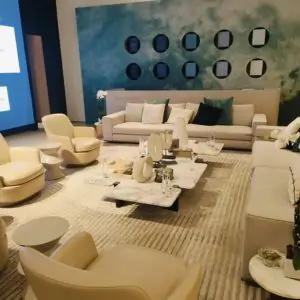 A stylish Dubai living room featuring a large screen, a cozy couch, and beautiful carpets.
