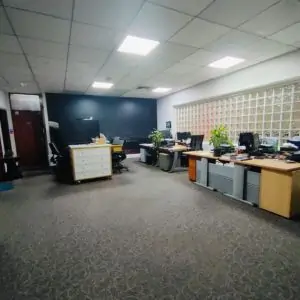 Carpets installed in dubai office interior featuring multiple desks with computers arranged for work .