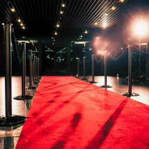Red exhibition carpet setup in Dubai with lights and stanchions