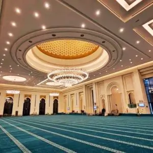 Grand Mosque of Kuwait with intricate architecture and a vibrant carpet, showcasing Islamic design elements.