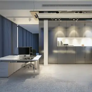 A modern office featuring a large desk and a sleek stainless steel cabinet with a beautiful office carpet in Dubai under it.