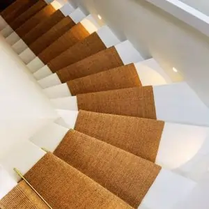 Staircase with brown carpeting and white walls, showcasing a stylish design typical of Dubai interiors.