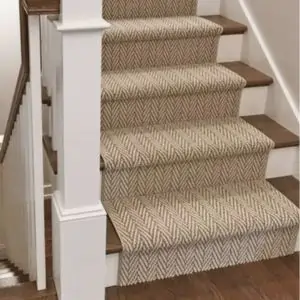 A stairway in Dubai featuring a decorative rug and a matching runner along the steps.