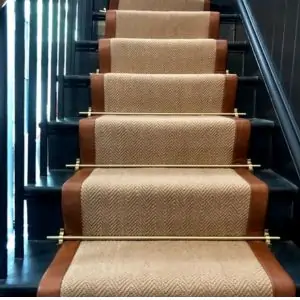 A staircase featuring a carpeted runner and a sleek metal rail, showcasing elegant design typical in Dubai interiors.